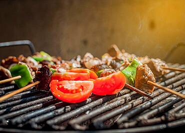 Roast beef skewers on a grill, Roast beef skewers grilling on a grill