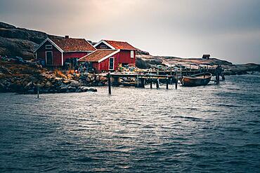 Swedish house, with jetty and boat by the sea, Tjurpannans Nature Preserve, Sweden, Scandinavia, Europe