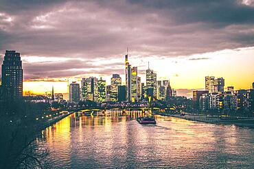 View over the river Main to the sunset skyline of Frankfurt am Main, evening, backlit sunset, Hesse, Germany, Europe