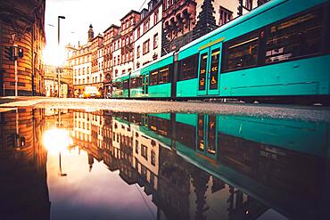 Tram at a stop in the sunrise, puddle, evening, night and illuminated, Frankfurt am Main, Hesse, Germany, Europe