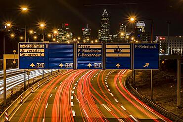 Motorway at night, long exposure with skyline, signs and light trails, Frankfurt am Main, Hesse, Germany, Europe