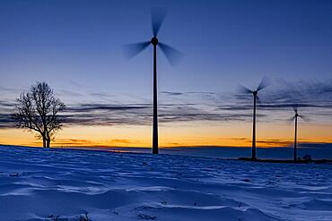 Wind turbines at blue hour in winter landscape, Ronsberg, Ostallgaeu, Bavaria, Germany, Europe