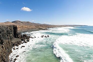 Waves in front of rocky coast, cliff and beach of El Cotillo, Fuerteventura, Canary Islands, Atlantic Ocean, Spain, Europe