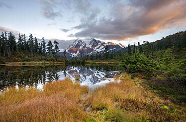 Mt. Shuksan glacier with snow reflecting in Picture Lake, forested mountain landscape in autumn, at sunset, Mt. Baker-Snoqualmie National Forest, Washington, USA, North America