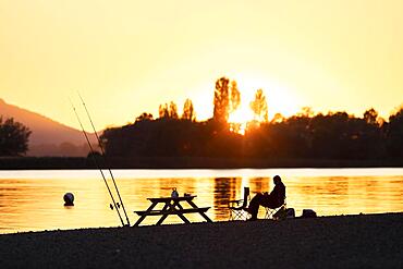 Angler at sunset and backlight at Lake Constance, Markelfingen, Baden-Wuerttemberg, Germany, Europe