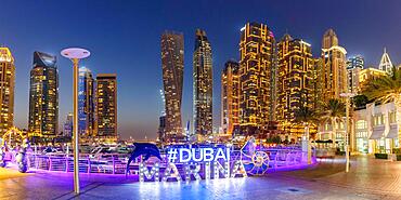 Dubai Marina Logo and Harbour Skyline Architecture Luxury Holiday in Arabia Panorama by Night in Dubai, United Arab Emirates, Asia