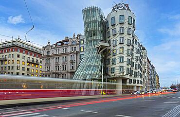 Moving tram in front of the dancing house, Prague, Czech Republic, Europe