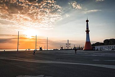 Willy-Brandt-Platz with lighthouse Unterfeuer at sunset, back light, seaside resort quay, Havenwelten, Bremerhaven, Bremen, Germany, Europe