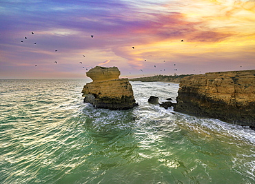 Aerial view of cliffs on Sao Rafael beach by the Atlantic Ocean at sunset, Algarve, Portugal, Europe