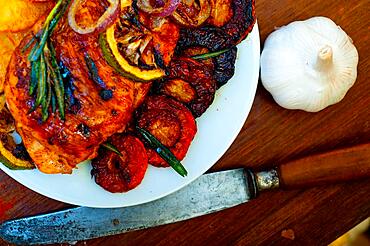 Roasted grilled BBQ chicken breast with herbs and spices rustic style