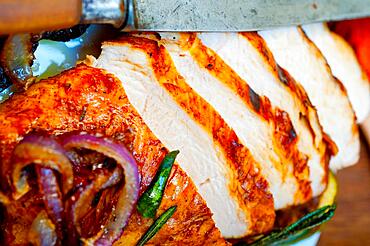 Roasted grilled BBQ chicken breast with herbs and spices rustic style