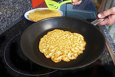 Swabian cuisine, pancakes, frying flaedle in the pan, spatula, preparing spinach cake spoon style, Swabian speciality, men's hands, Germany, Europe