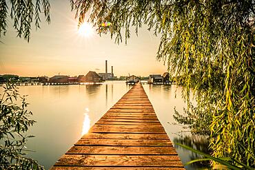 Small wooden houses with a jetty in a lake, they serve as fishing and holiday homes for Hungarians. Beautiful landscape photo at sunset, Lake Bokodi, Bokod, Hungary, Europe