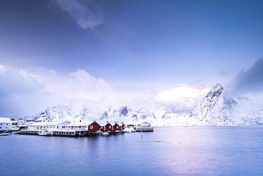 Rorbuer cabins from Hamnoy by the fjord, snowy mountains in the back, Hamnoy, Moskenesoya, Lofoten, Norway, Europe