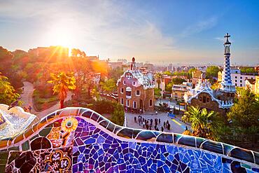 Barcelona city view from Guell Park with colorful mosaic buildings in tourist attraction Park Guell in the morning on sunrise, Barcelona, Spain, Europe