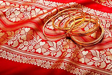 Indian sari with golden bangles clouse up