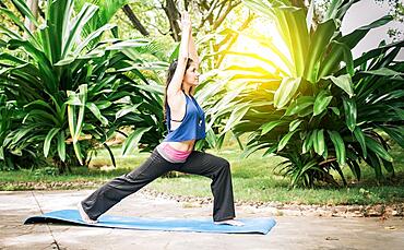 Woman doing yoga outdoors, A girl performing flexibility yoga, young girl showing yoga styles outdoors, yoga and fitness concept