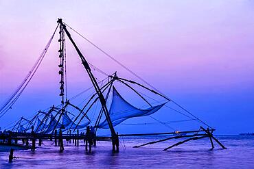 Kochi chinese fishnets on sunset in Fort Kochin, Kochi, Kerala, India, Asia