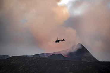 Helicopter flying over smoking active volcanic crater, glowing lava, volcanic eruption, active table volcano Fagradalsfjall, Krysuvik volcanic system, Reykjanes Peninsula, Iceland, Europe