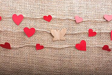 Love concept with heart shaped papers on linen threads