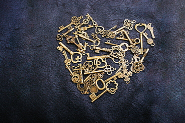 Retro metal keys form a heart shape on black