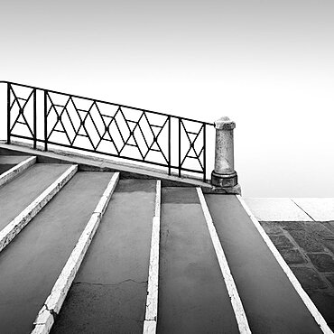 Black and white photograph of a bridge railing in the fog at the Fondamenta Nuove in the north of Venice, Italy, Europe