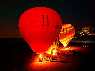 Hot air balloon, balloon glow in the early morning hours near Luxor, Egypt, Africa