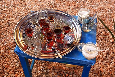 Silver tray with tea glasses stands on a blue table, Upper Egypt, Egypt, Africa