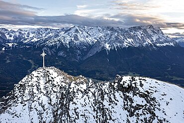 Alpine panorama with Zugspitze and summit cross of the Kramer, aerial view, mountains with snow in the evening, summit of the Kramer, Garmisch, Bavaria, Germany, Europe