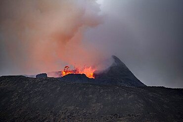 Smoking active volcanic crater, Glowing lava splashes over crater rim, Volcanic eruption, Active table volcano Fagradalsfjall, Krysuvik volcanic system, Reykjanes Peninsula, Iceland, Europe