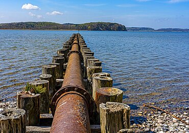 Rusty pipeline between groynes on the Jasmund Bodden, Ruegen Island, Mecklenburg-Western Pomerania, Germany, Europe