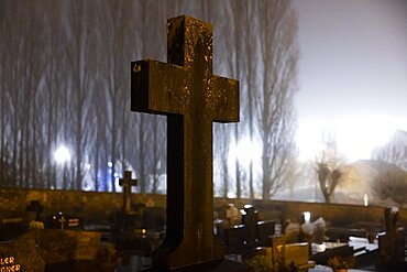 Cross in a cemetery at night with street lighting, Berdorf, Luxembourg's Little Switzerland, Luxembourg, Europe