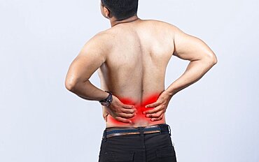 Person with back problems on isolated background, lumbar problems concept, A man with spine problems, a sore person with back pain