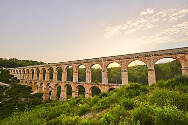 Old roman aqueduct at sunrise, Aqueeducte de les Ferreres, Devil's Bridge, Pont del Diable, Catalonia, Spain, Europe