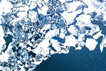 Droneview on a lake with floating ice sheet in the montain range Hemsedalfjell, Provinz Viken, Norway, Europe