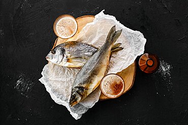 Whole jerky sea bass, dorado and a beer