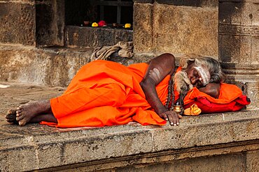 TIRUVANAMALLAI, INDIA, JANUARY 7, 2010: Sadhu, religious ascetic or holy person, sleeping in Hindu temple Arunachaleswar. Tiruvanamallai, Tamil Nadu, India, Asia