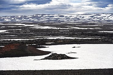 Snow-covered volcanic landscape with volcanic sand and petrified lava, crater of Askja volcano, Icelandic highlands, Iceland, Europe