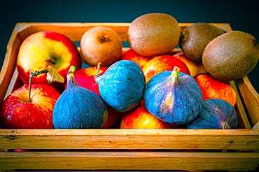 Apples, kiwi and fig in a wooden fruit basket as a healthy meal, Hanover, Lower Saxony, Germany, Europe