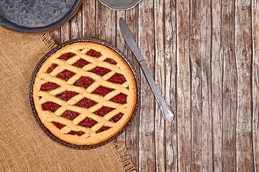 Top view of homemade pie called 'Linzer Torte', a traditional Austrian shortcake pastry topped with fruit preserves and ground nuts with lattice design