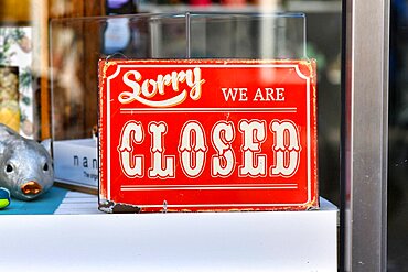 Heidelberg, Germany, April 2020: Red retro style Closed sign in shopping window, Europe