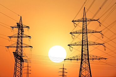 Overhead power lines, high-voltage pylons, power lines, setting sun, sunset, Baden-Wuerttemberg