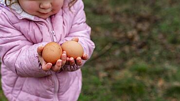 close up kid holding eggs