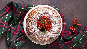 flat lay christmas cake with red berries