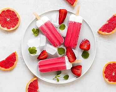 top view yummy popsicles plate with red grapefruit