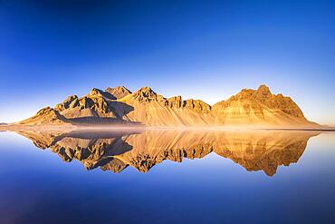 Mountain massif reflected in water, Klifatindur with Vestrahorn, Stokksnes, Hoefn, Austurland, Iceland, Europe