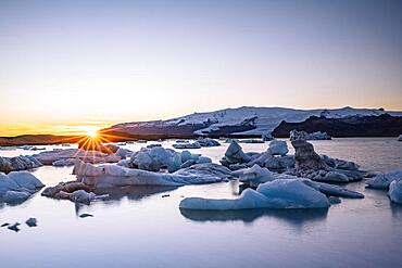 Joekulsarlon glacier lagoon at sunset, icebergs with glacier, Vatnajoekull National Park, Hornafjoerour, South Iceland, Iceland, Europe