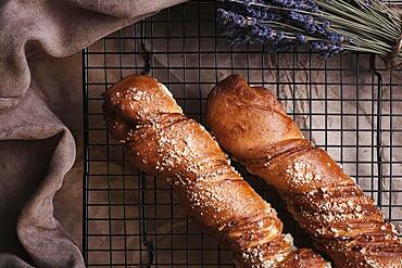 White bread in a basket and lavender flowers in vintage style