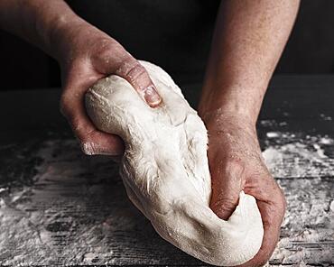 Cooking dough by elderly woman cook hands for homemade pastry bread, pizza, pasta recipe preparation on table background