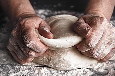 Cooking dough by elderly woman cook hands for homemade pastry bread, pizza, pasta recipe preparation on table background